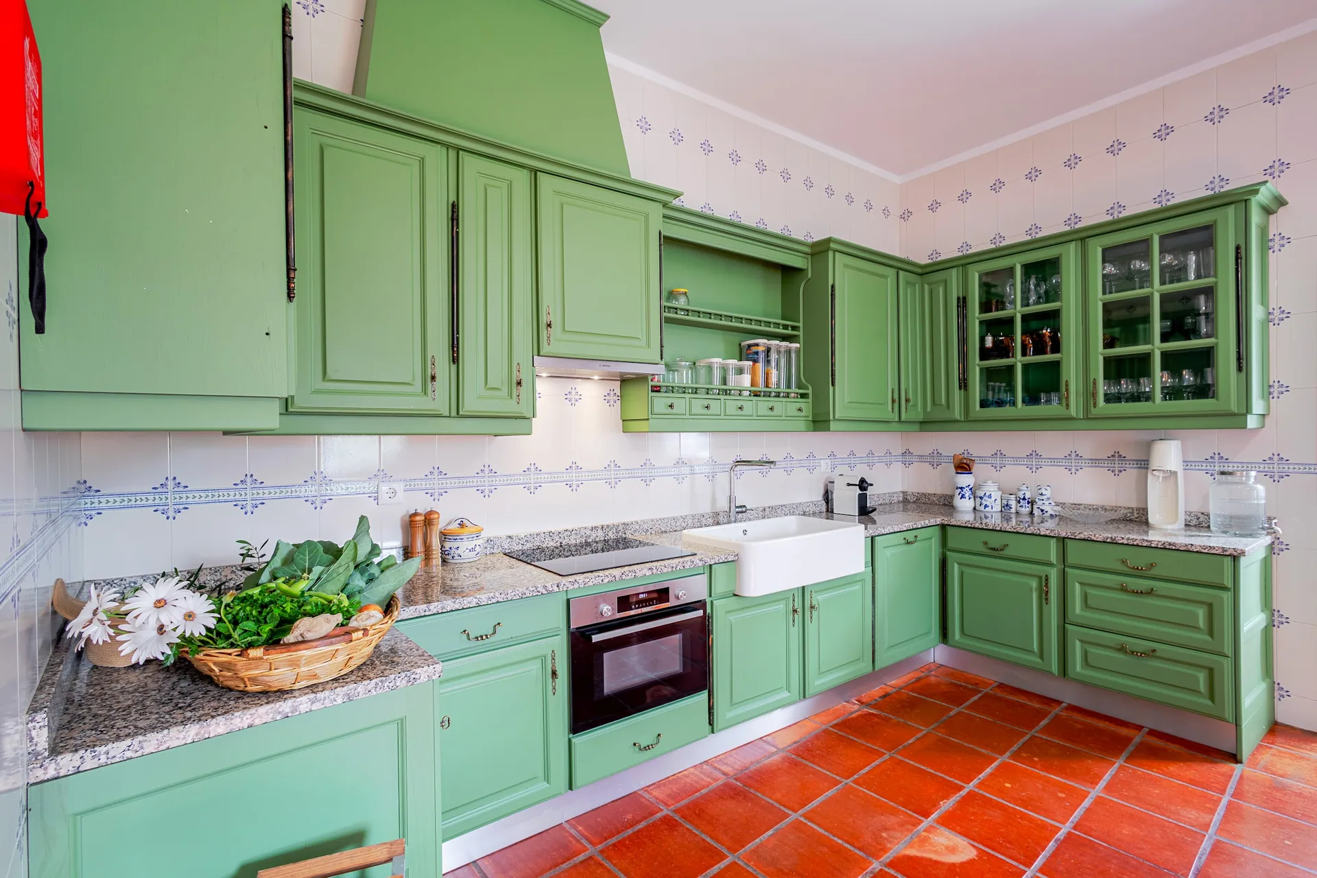 Green kitchen with granite worktop
