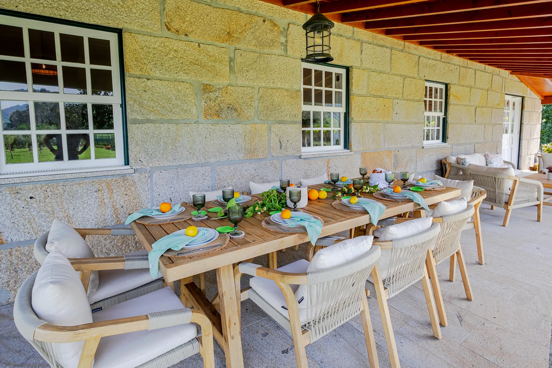 Long table laid under the granite porch