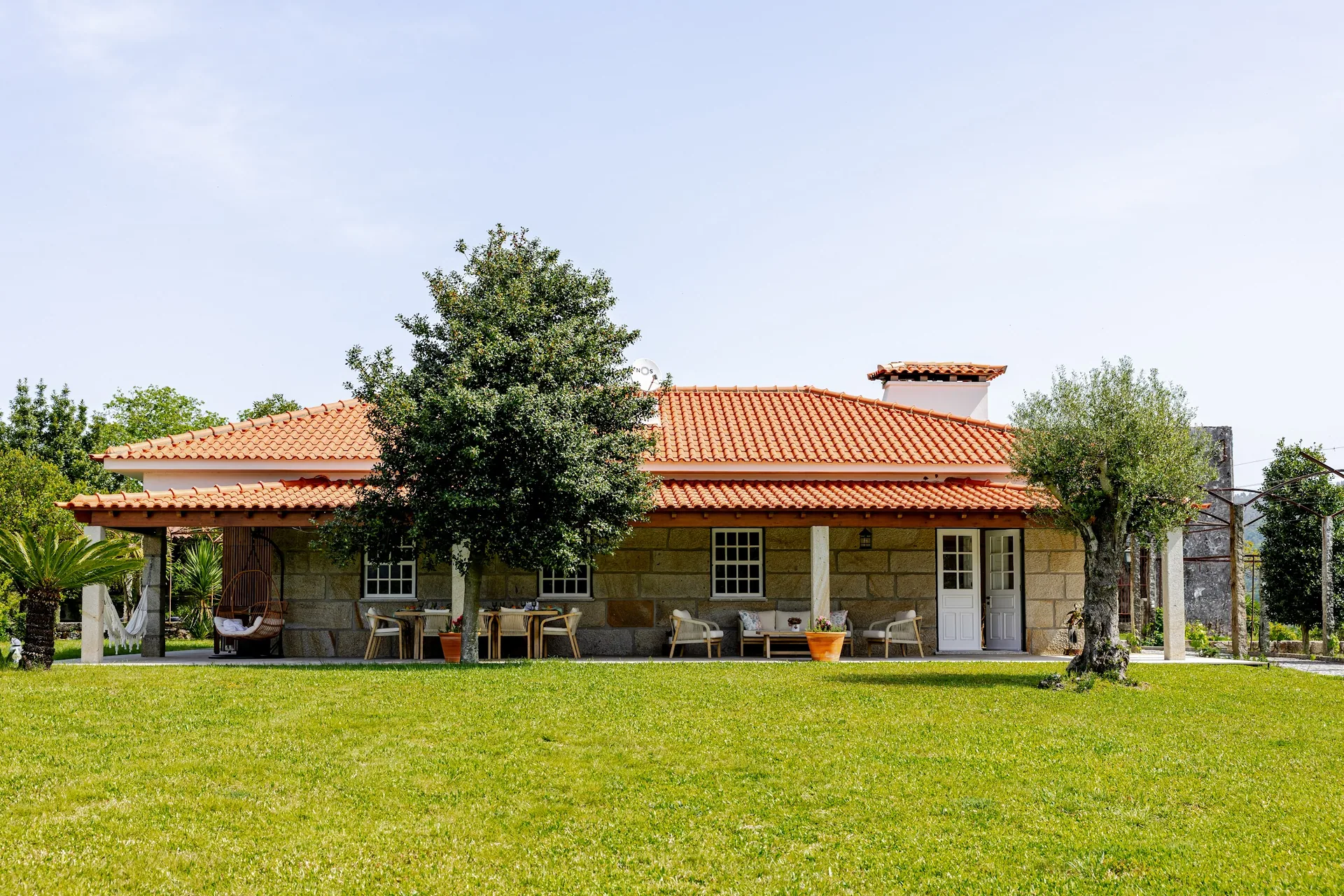 Farmhouse and lawn with olive trees